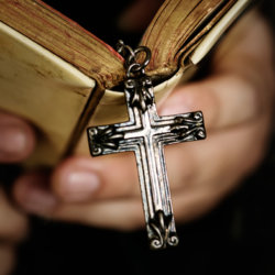 close-up-of-a-man-reading-a-bible-with-cross-CKM3GJU close-up-of-a-man-reading-a-bible-with-cross-CKM3GJU